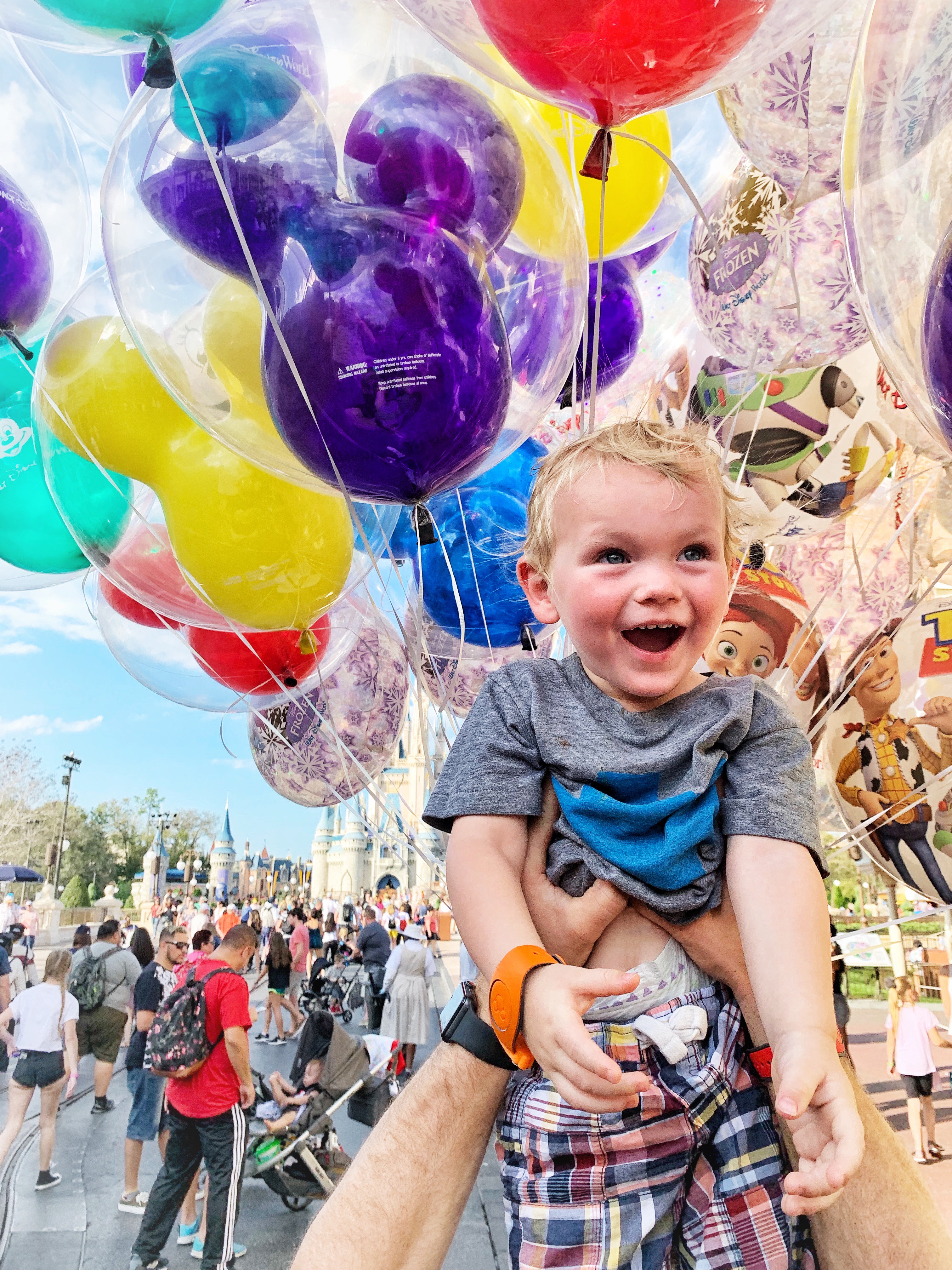 image of a toddler held up around lots of balloons