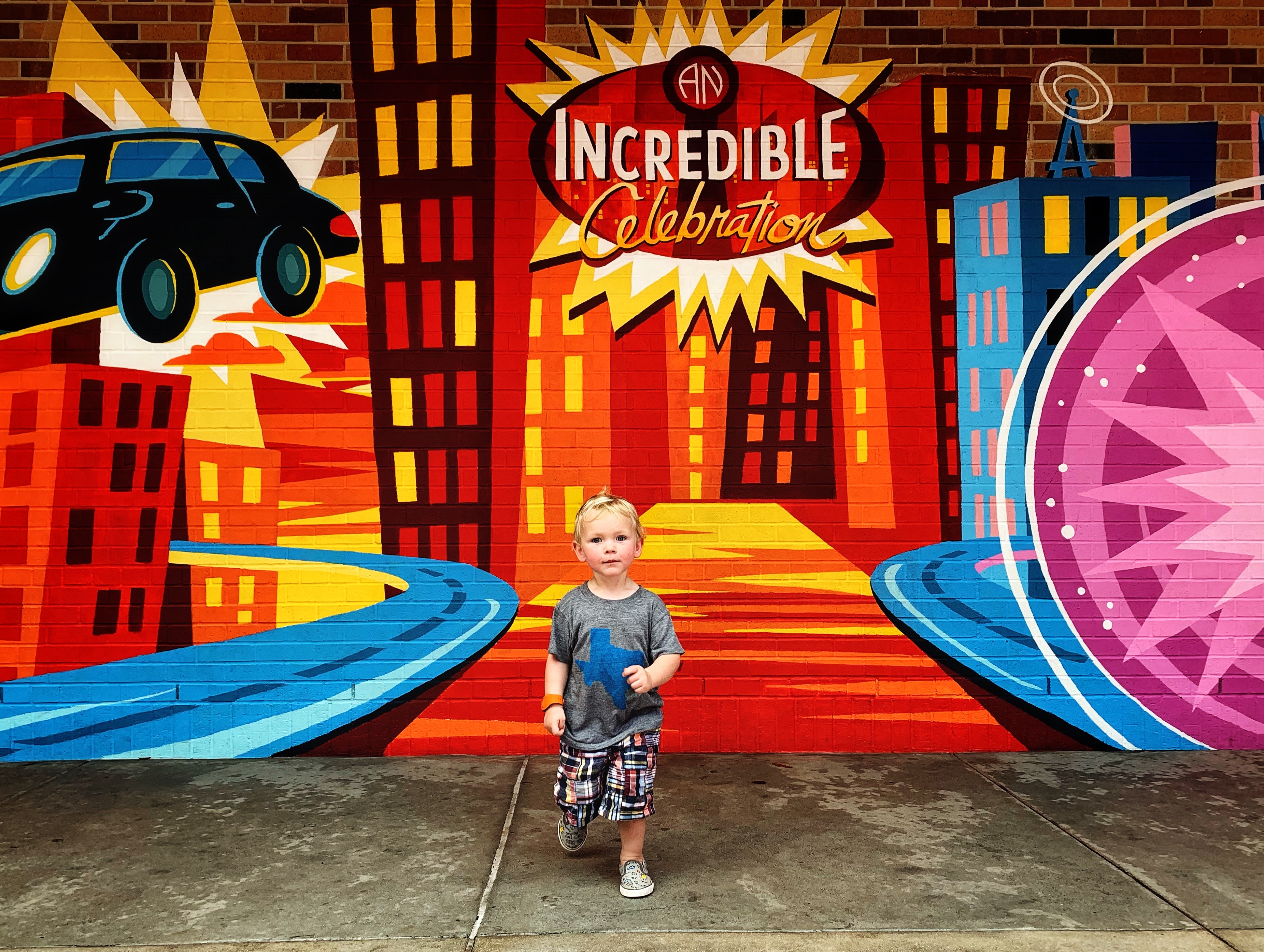 image of toddler posing in front of Incredible painting